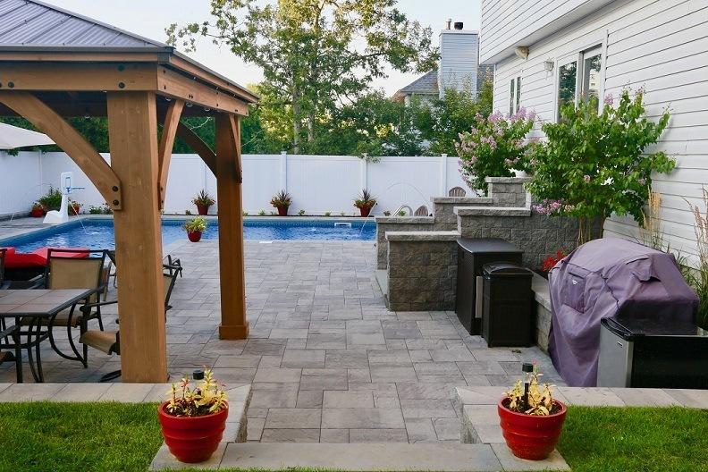 Stone paver patio and landscaped yard